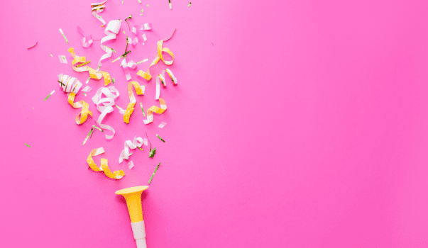 yellow and white confetti on a pink background