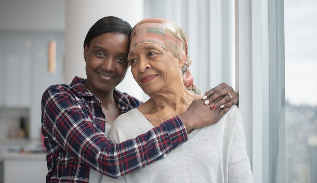 a young woman hugs her grandmother