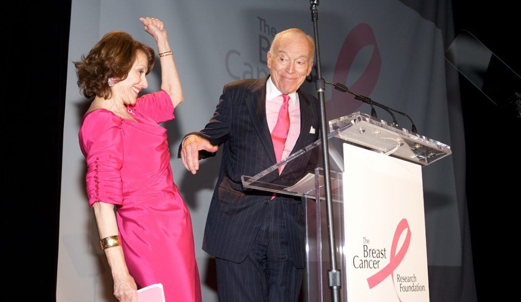 candid photo of Evelyn H. Lauder in a pink dress celebrating at a BCRF event with her husband