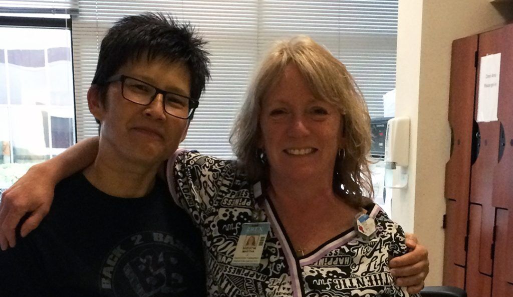 rachelle fong poses with her radiation technician at the hospital where she as treated