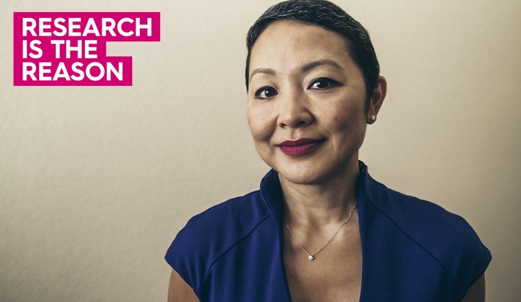 a portrait of yen wearing a blue shirt smiling