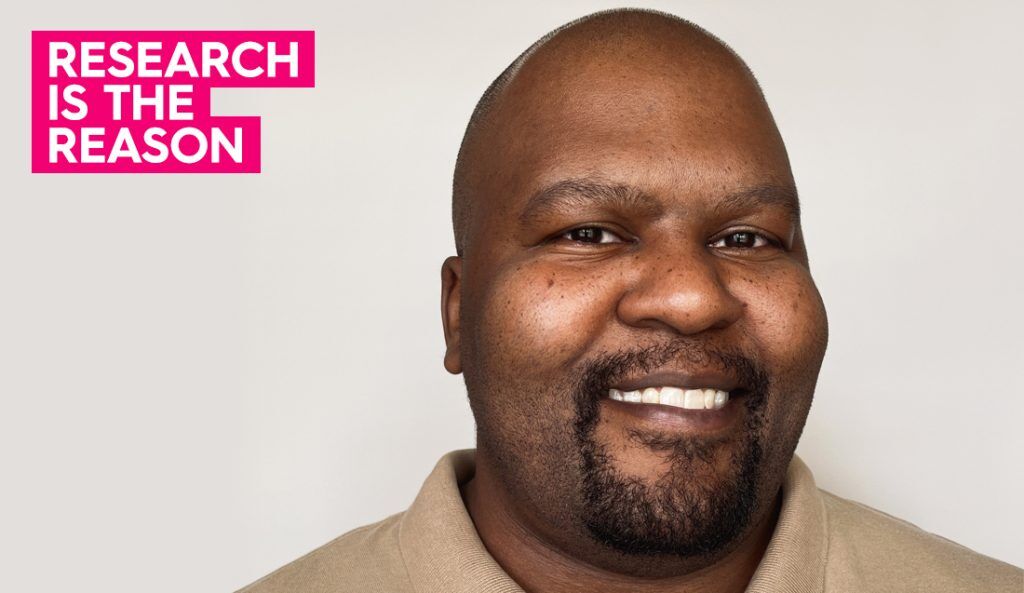 a portrait of aubrey smiling at the camera wearing a tan polo shirt