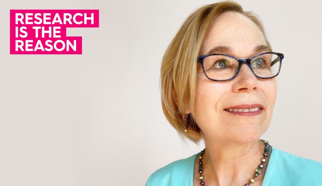 a portrait of claire wearing a blue shirt and glasses