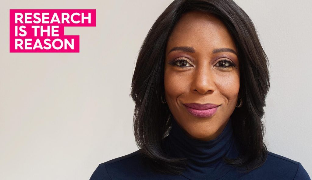 portrait of maya rockeymoore cummings wearing a navy turtleneck sweater looking at the camera