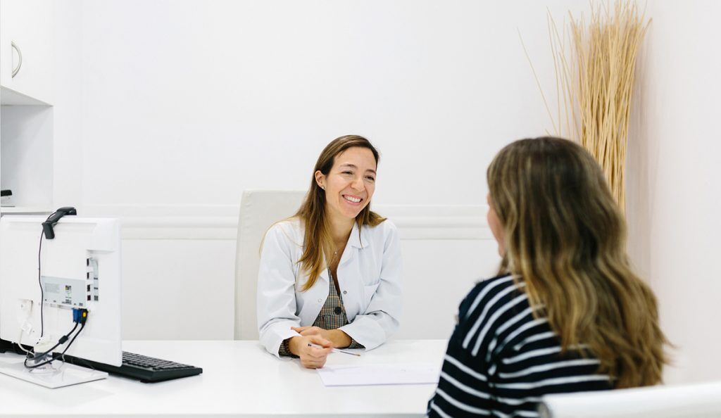 physician-researcher with a patient