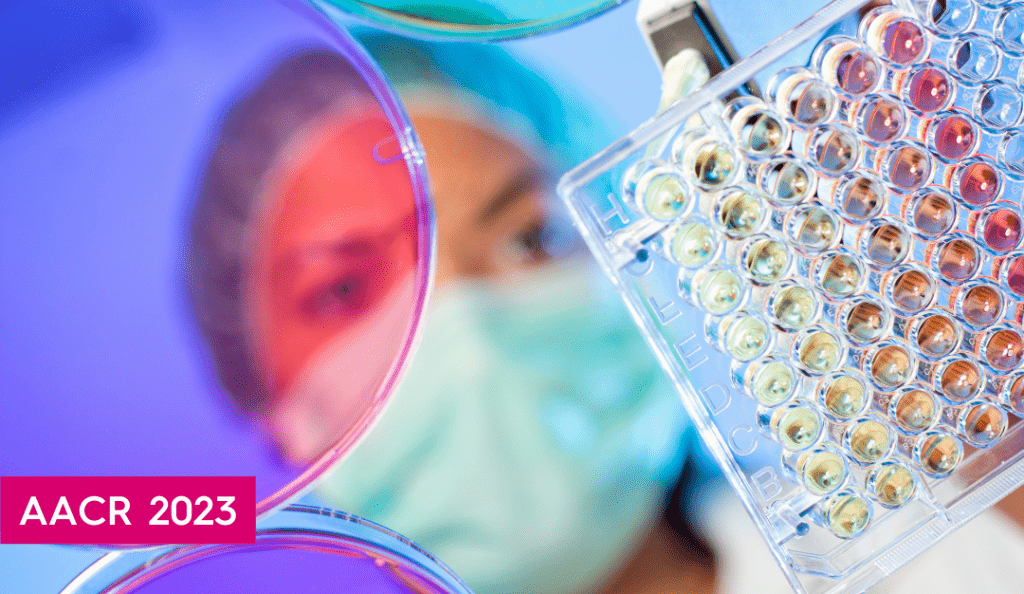 a stock photo of a researcher using a pipette tool with the words AACR 2023 in a pink box