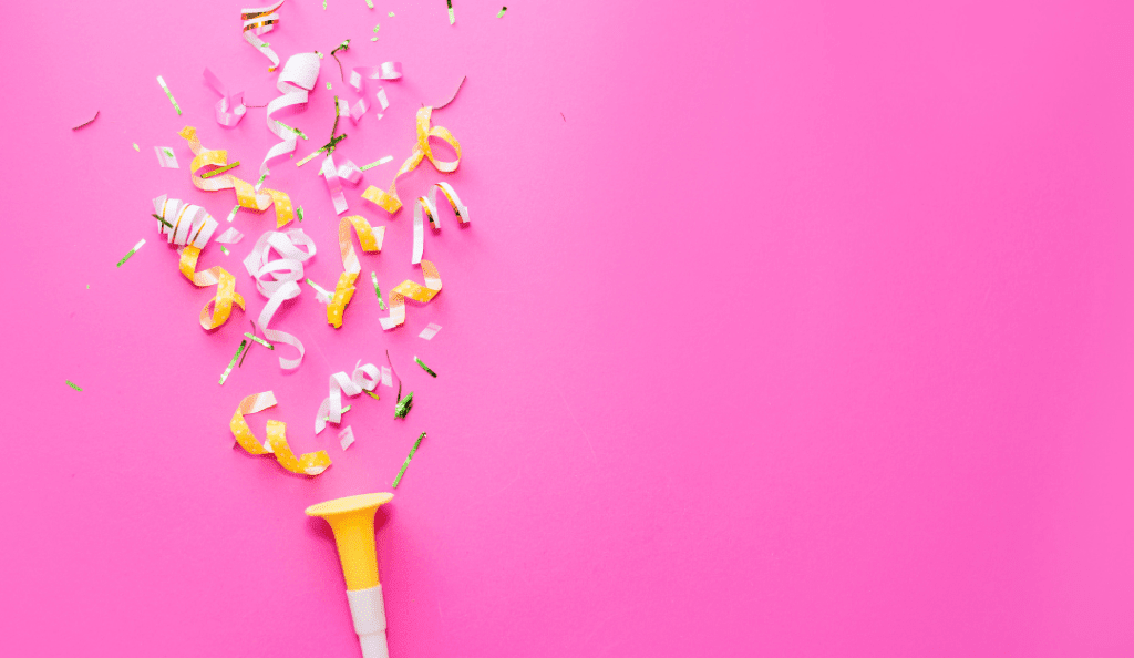 yellow and white confetti on a pink background