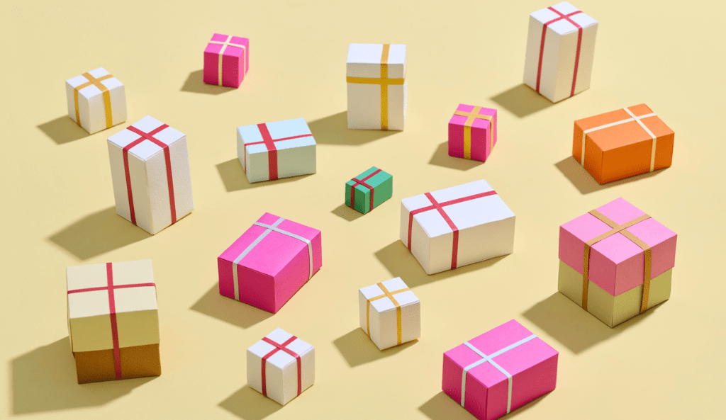 Colorful Gift Boxes Arranged on a Yellow Background in Various Sizes