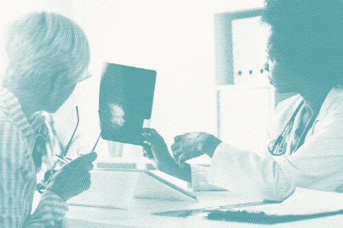 A doctor shows a woman her mammogram results