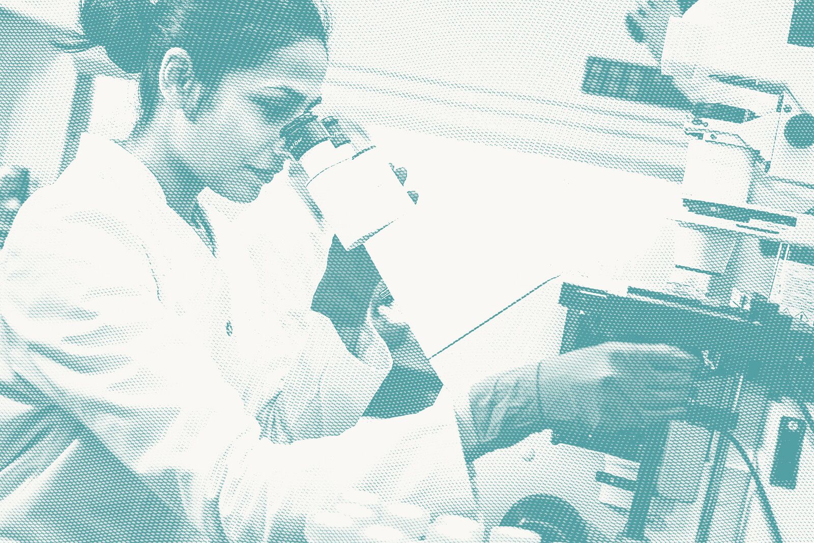 a pathologist looks at a microscope