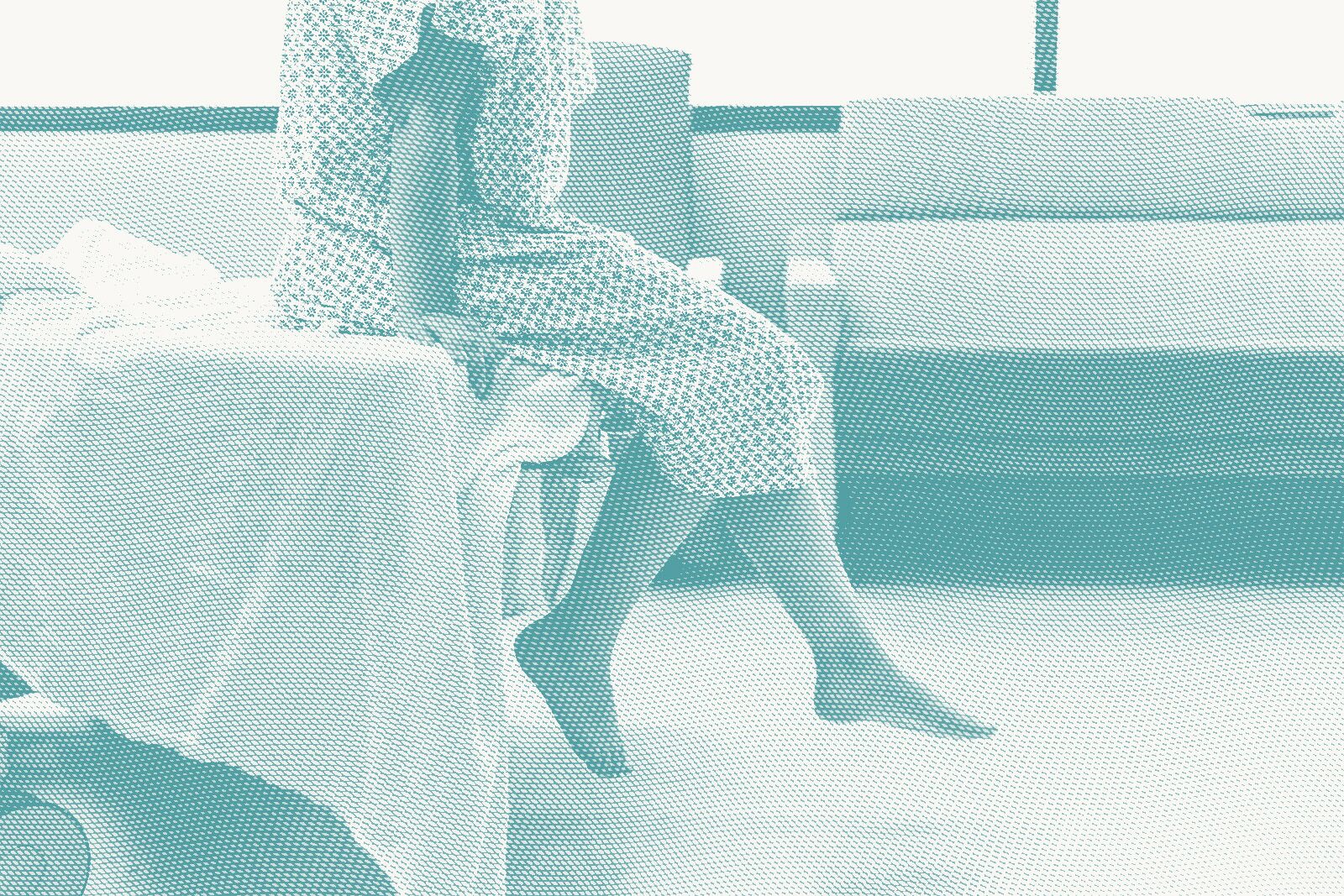A woman wearing a hospital gown waits for a procedure