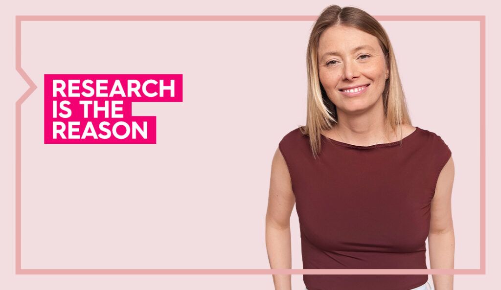 a portrait of julia against a pink background