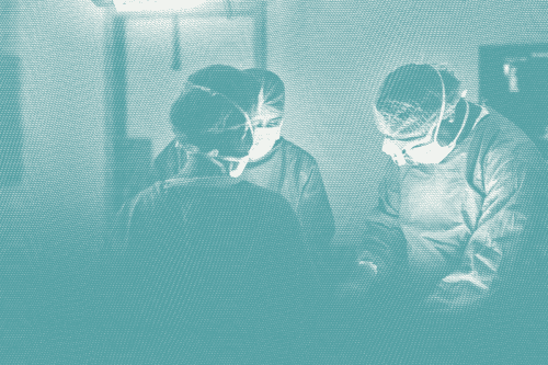 Several surgeons around a patient; illustrative of breast cancer surgery