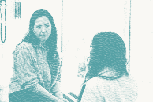 a woman speaks with her doctor, she has a concerned expression