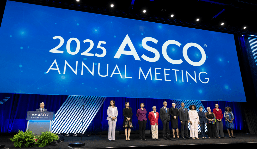 researchers stand on a stage to receive awards at ASCO 2025