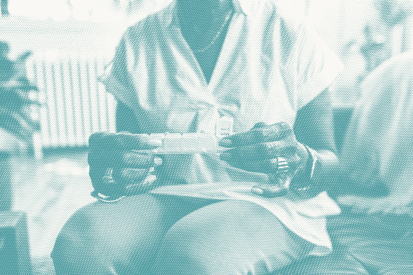 an older woman looks at a pill organizer to take hormone therapy for breast cancer