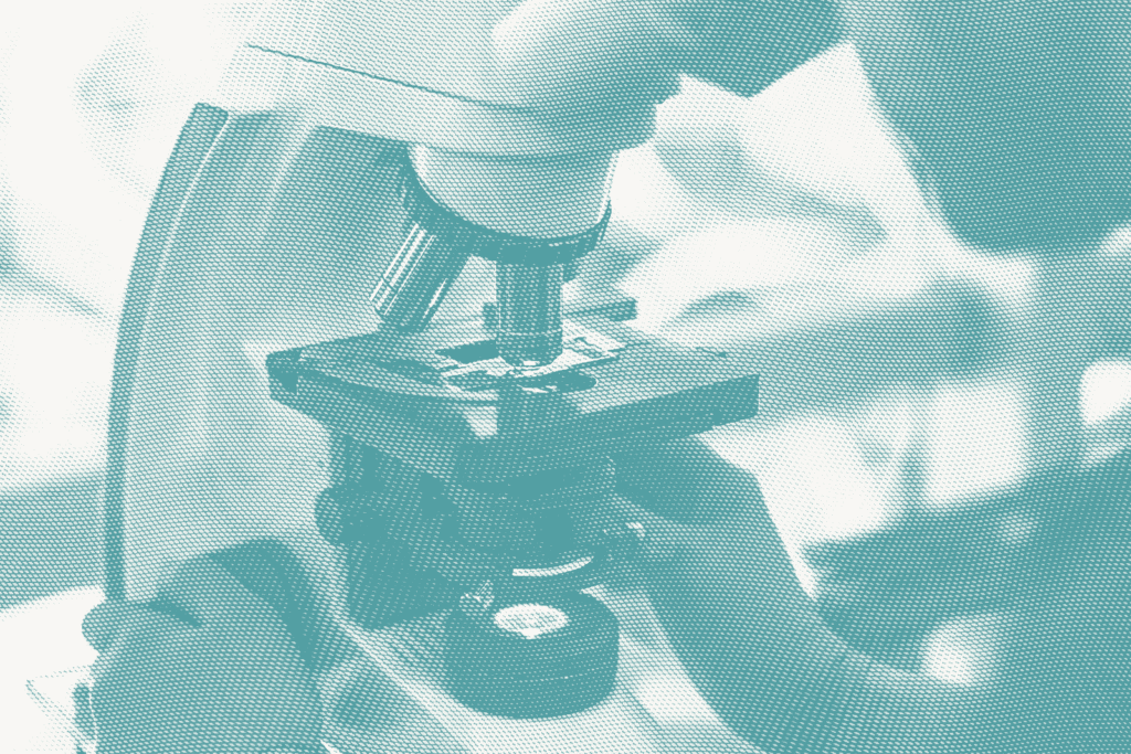 a pathologist looks into a microscope. pathologists conduct tests to determine a breast cancer's molecular subtype, such as luminal A—the most common.