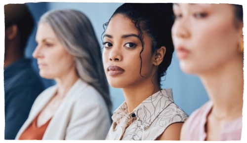 a young woman of color looks at the camera