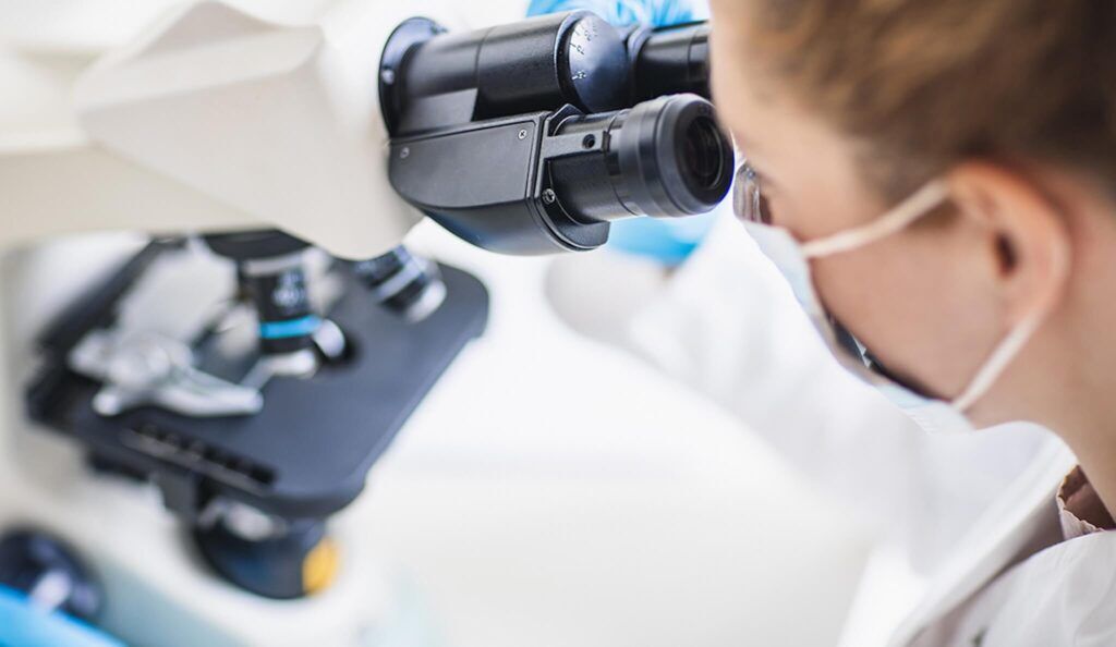 A female scientist looking into a microscope