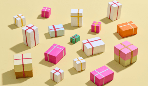Colorful Gift Boxes Arranged on a Yellow Background in Various Sizes