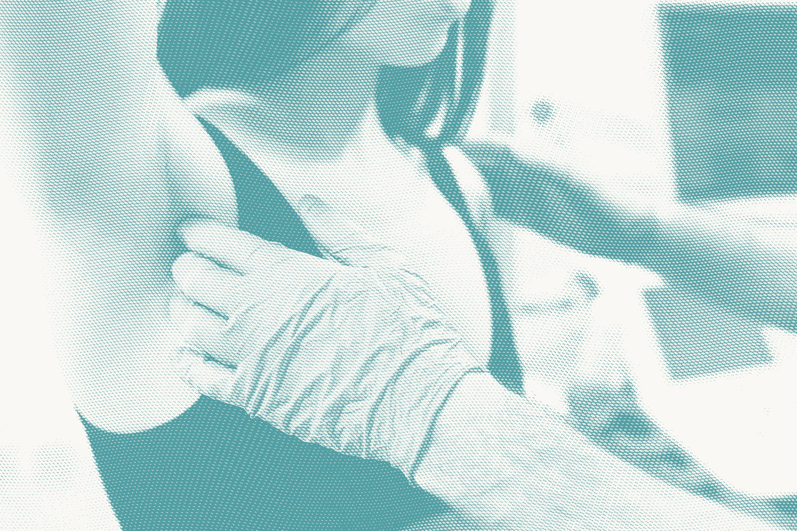 A doctor wears gloves and does a breast exam on a woman, focusing on her lymph nodes under her armpits.