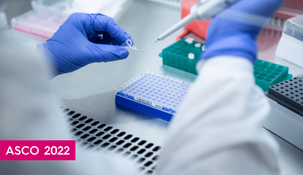 a lab worker wearing blue gloves prepares a sample