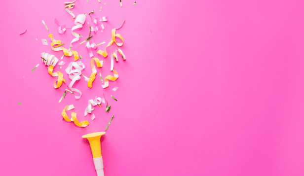 yellow and white confetti on a pink background